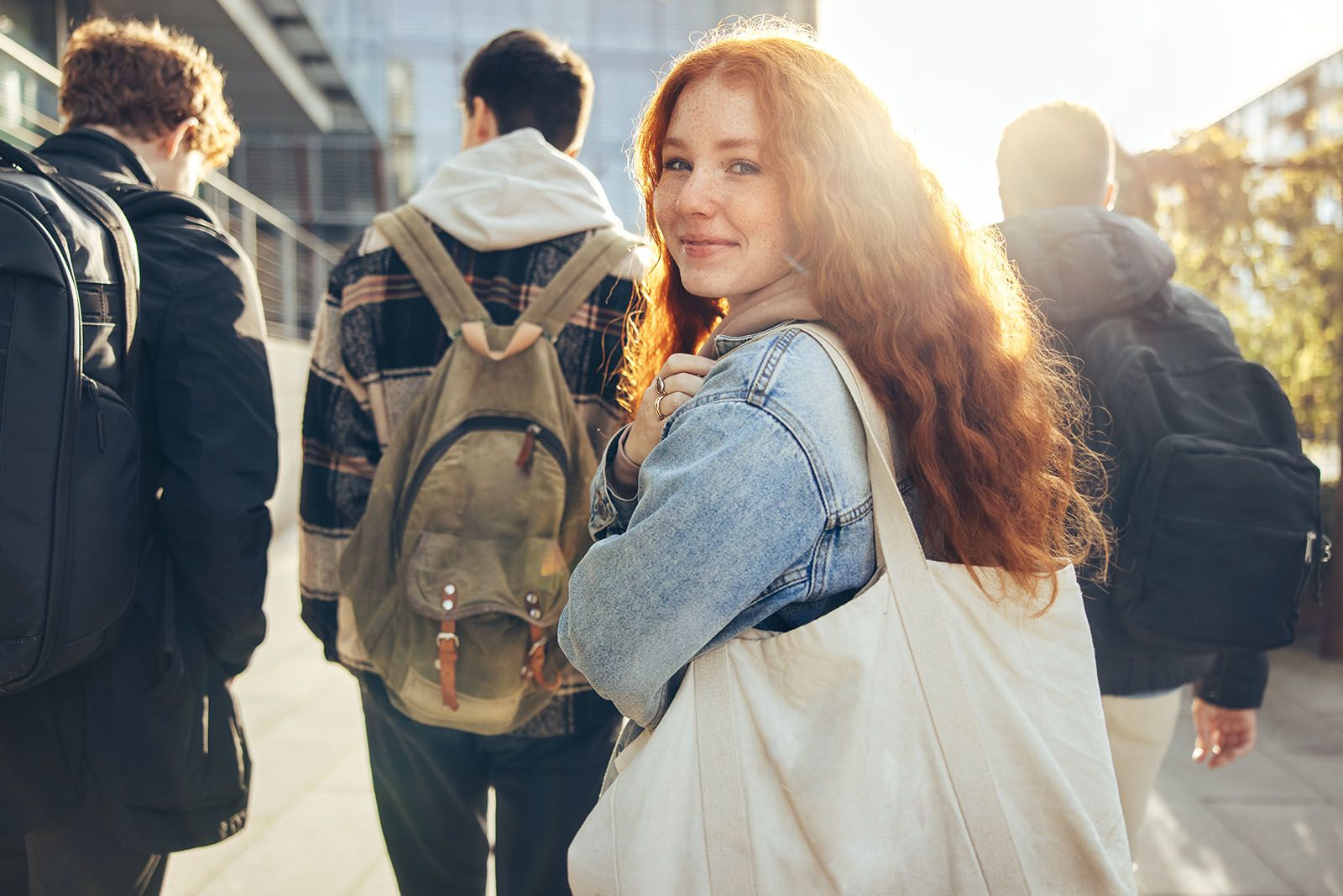 Female student glancing back while going for a class in college