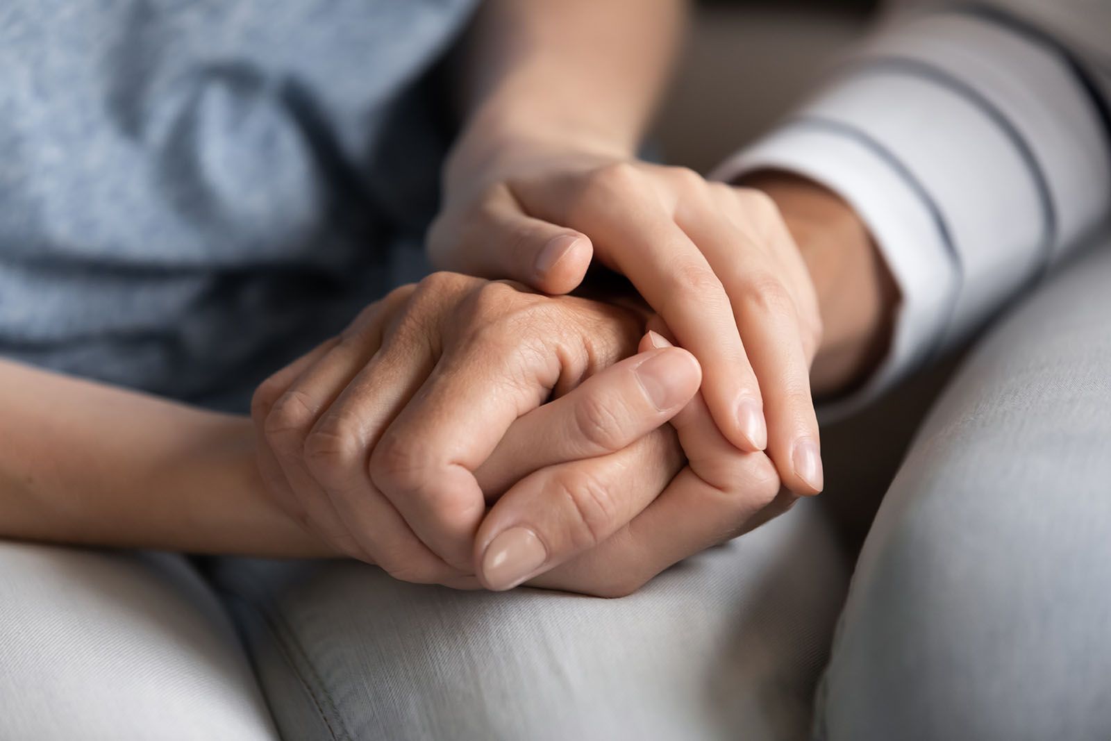 A set of holding hands rested on knees