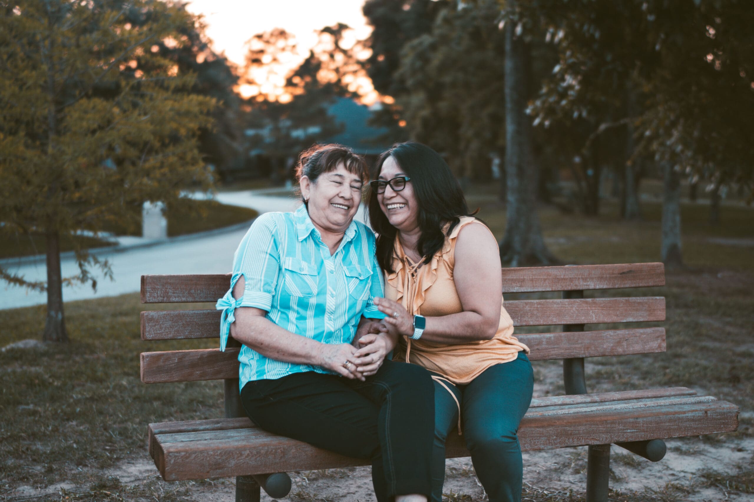 Two women sitting outside on a bench