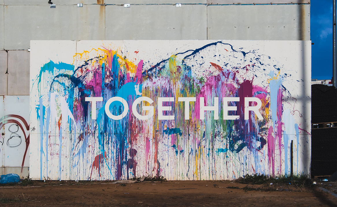 A colourful mural that has the word "together"