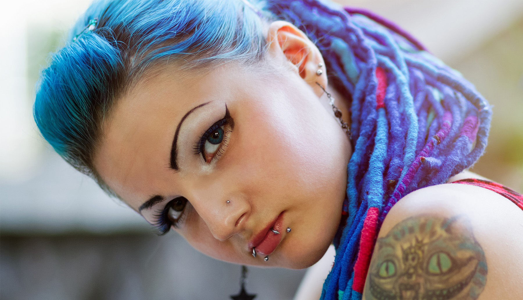 A young woman with blue hair