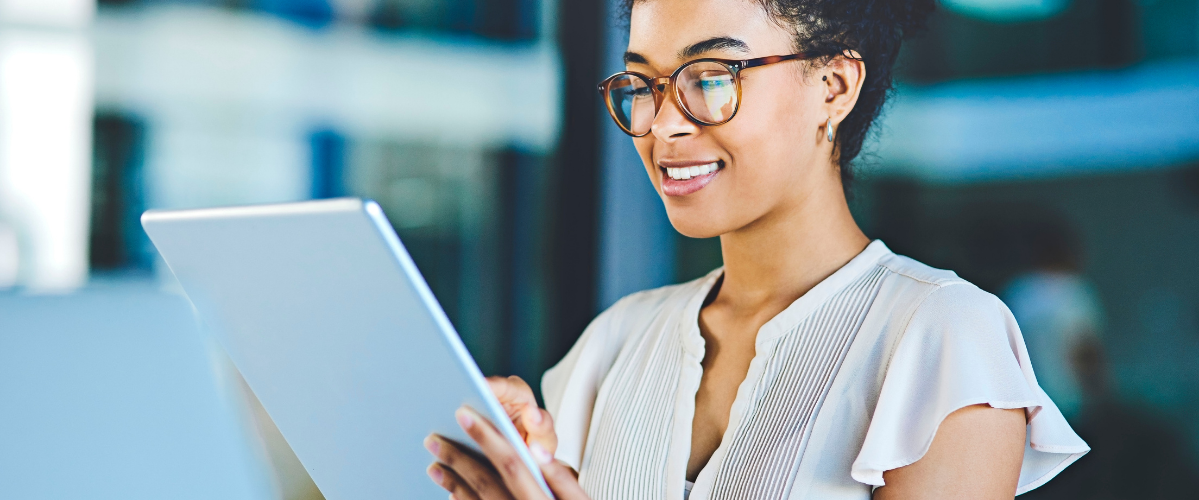A woman wearing glasses using a tablet