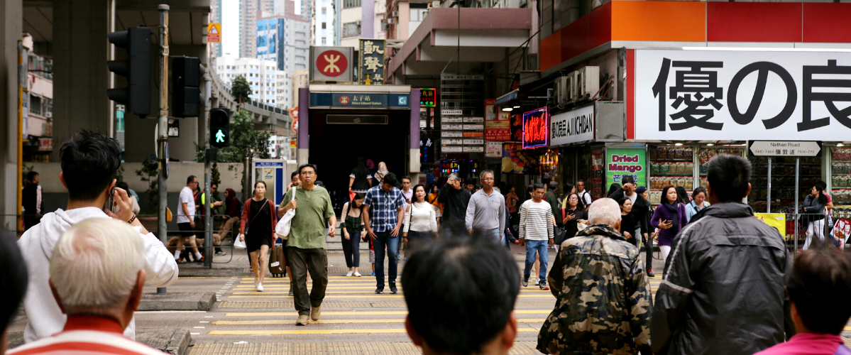 People walking around a busy street