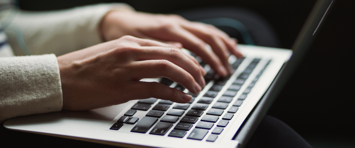 hands typing on a keyboard