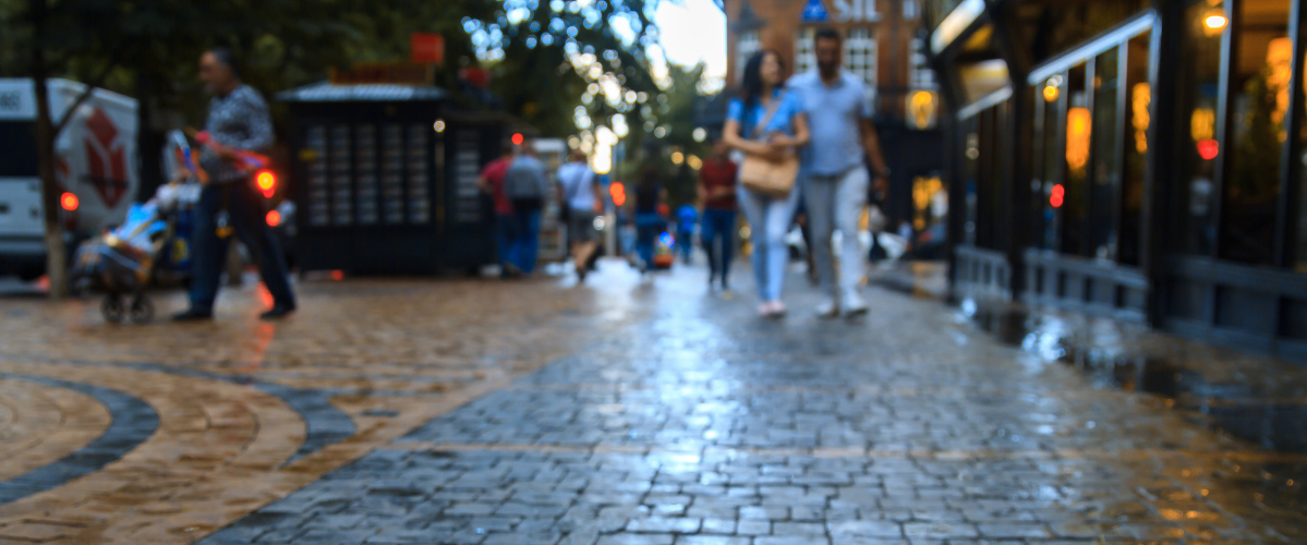 A blurry image of people walking down a busy street