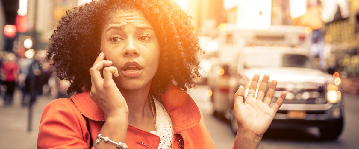 A woman outside making a call on a cell phone