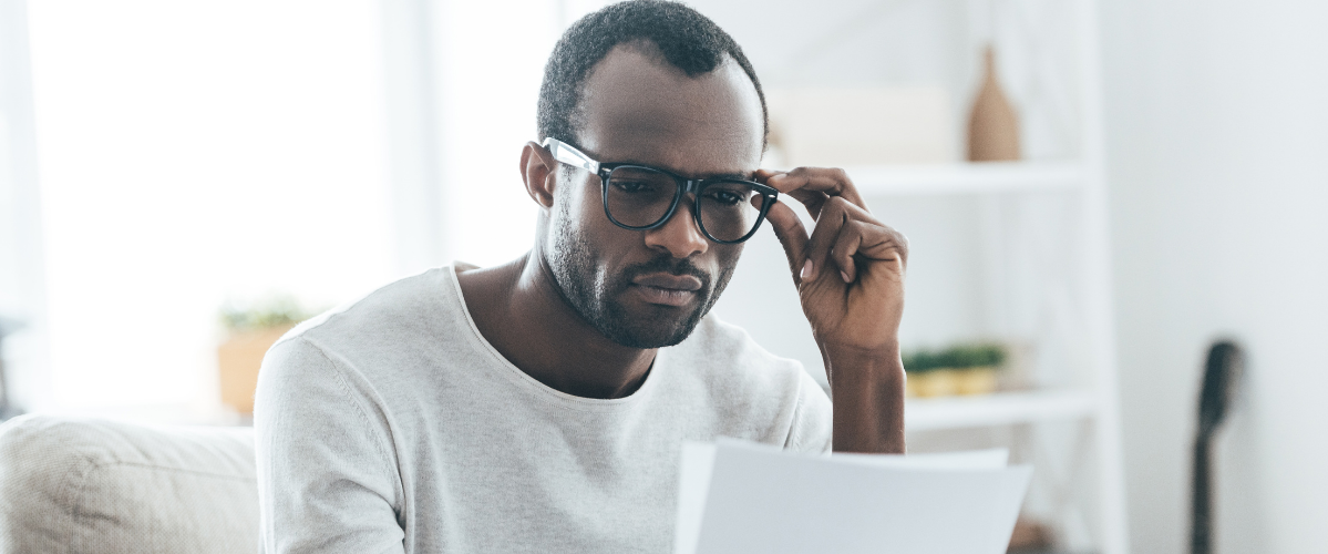 a man reads something on a piece of paper