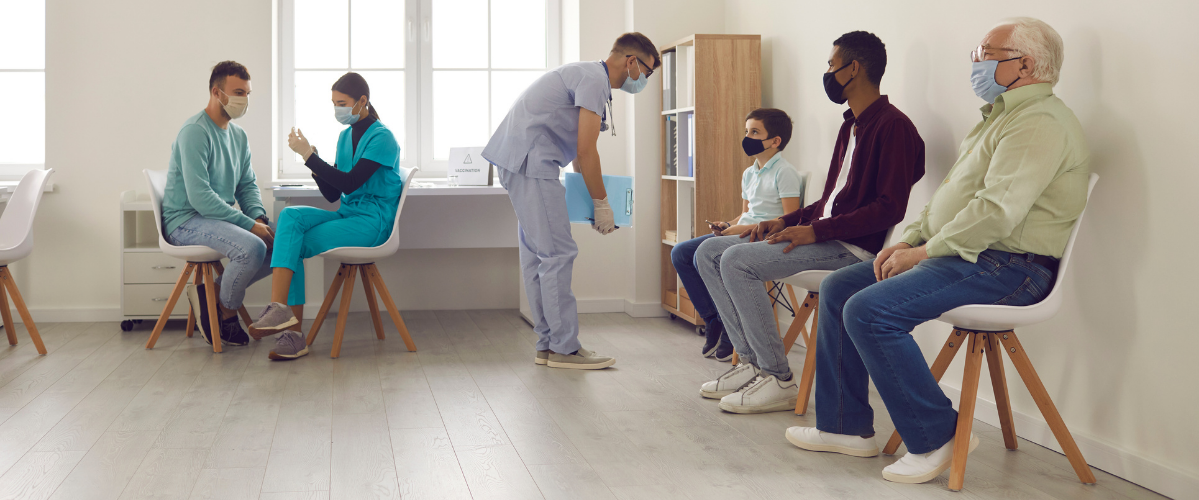 People waiting to get vaccinated wearing masks