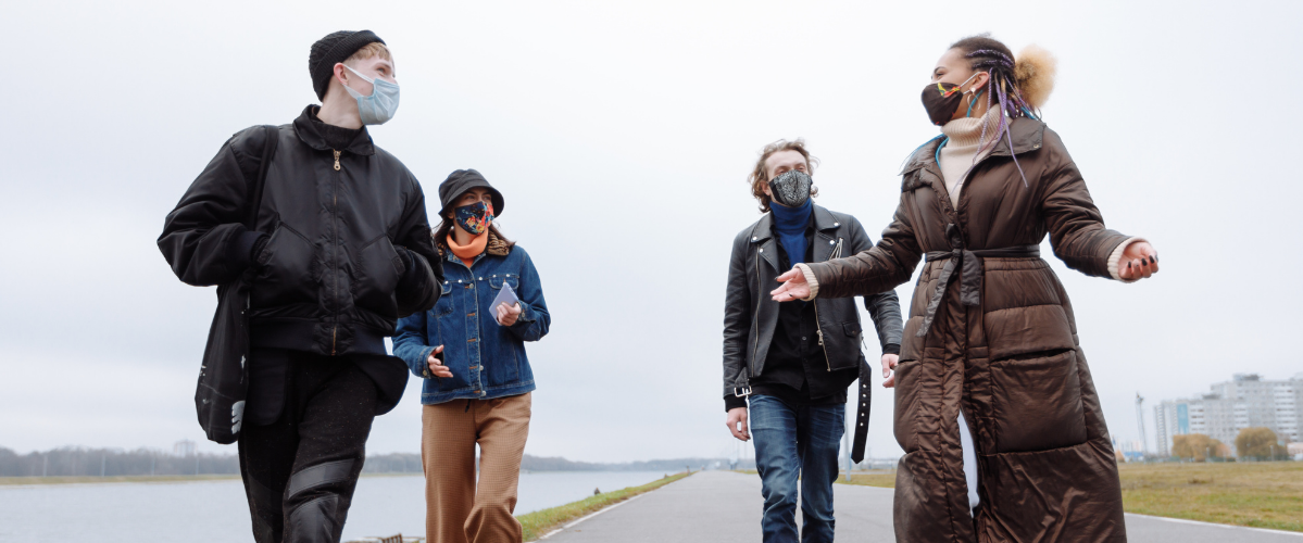 Four friends out for a walk wearing masks