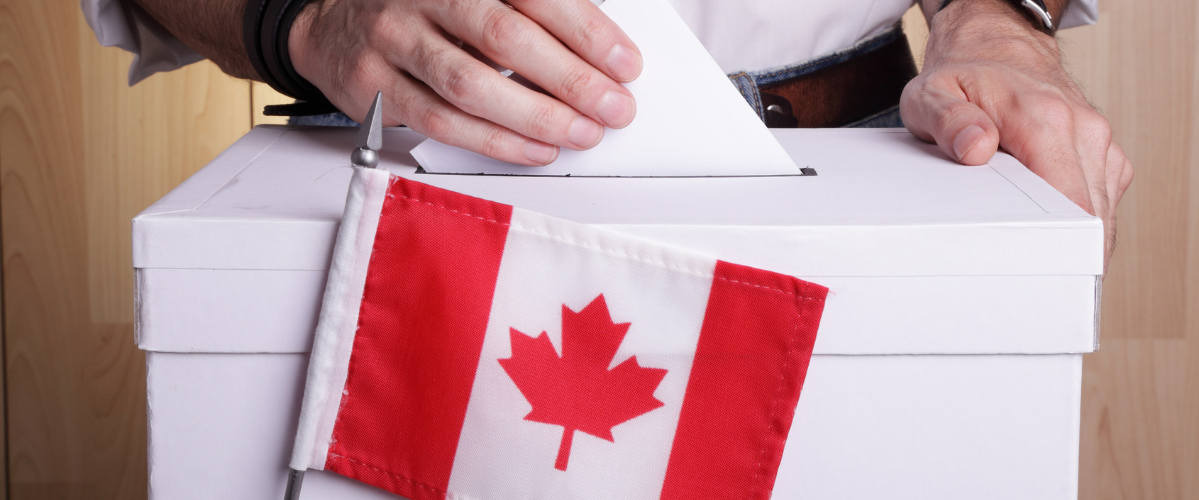 a voter casts a ballot in canada